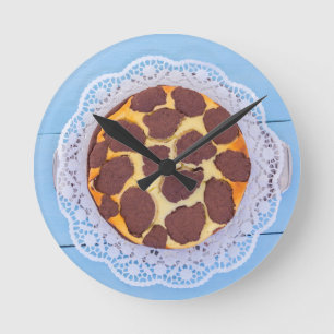 Russian chocolate cheesecake on a blue wooden back round clock