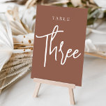 Rust Hand Scripted Table THREE Table Number<br><div class="desc">Simple and chic table number cards in earth tone rust brown and white make an elegant statement at your wedding or event. Design features "table [number]" in an eyecatching mix of classic serif and handwritten script lettering. Design repeats on both sides. Individually numbered cards sold separately; order each table number...</div>
