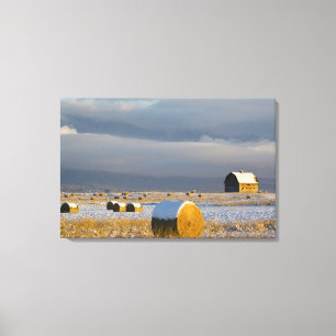 Rustic barn and hay bales after a fresh snow 2 canvas print