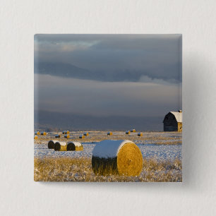 Rustic barn and hay bales after a fresh snow 3 2 inch square button