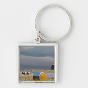 Rustic barn and hay bales after a fresh snow 3 keychain