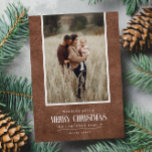 Rustic Brown Winter Christmas Single Photo Holiday Card<br><div class="desc">This simple and rustic holiday design features your best portrait photo over a rustic paper texture in brown colour and the word "Merry Christmas" in vintage script text . Perfect for farmhouse style greeting cards. Easily add your best photo, your family names and year using the template. Add a personal...</div>