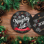 Rustic Chalkboard "On the Naughty List." Christmas Ceramic Ornament<br><div class="desc">Add a touch of rustic charm to your holiday decor with this elegant chalkboard ornament. Handcrafted from flat circle MDF, it features the whimsical phrase "On the Naughty List. I Regret Nothing!" in matching typography on a black chalkboard background. Adorned with delicate white ivy leaves and festive red holly berries,...</div>