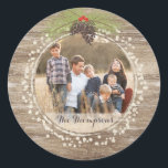 Rustic Christmas Pine Branch & Berries Wood Photo Classic Round Sticker<br><div class="desc">This rustic round Christmas sticker features a pine branch bough, berries and pinecones set against a warm brown wood background. Customize with a special photo and your family name (or delete). Perfect for a rustic, north woods, vintage look for your holiday envelopes or gift giving. Please check out our coordinating...</div>