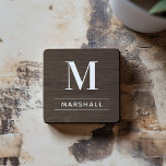 Rustic Dark Brown Wood Custom Monogram Initial Coaster<br><div class="desc">This simply elegant custom monogrammed beverage coaster set features classic white monogram text that can be personalized with a last name initial and last name. A beautiful keepsake gift for a newlywed couple, family, or new homeowners. A dark walnut brown faux wood grain background adds a rustic textured look to...</div>