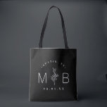 Rustic Floral Stem Wedding Monogram | Black Tote Bag<br><div class="desc">Custom printed tote bags make a fun and functional wedding favour your guests will love! Personalize the template with the bride and groom's names or monogram initials. Add your wedding date, the city, state or venue name or any other custom text. This modern rustic logo-style design has a simple floral...</div>