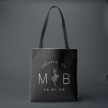 Rustic Floral Stem Wedding Monogram | Black Tote Bag<br><div class="desc">Custom printed tote bags make a fun and functional wedding favour your guests will love! Personalize the template with the bride and groom's names or monogram initials. Add your wedding date, the city, state or venue name or any other custom text. This modern rustic logo-style design has a simple floral...</div>