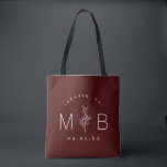 Rustic Floral Stem Wedding Monogram | Burgundy Tote Bag<br><div class="desc">Custom printed tote bags make a fun and functional wedding favour your guests will love! Personalize the template with the bride and groom's names or monogram initials. Add your wedding date, the city, state or venue name or any other custom text. This modern rustic logo-style design has a simple floral...</div>