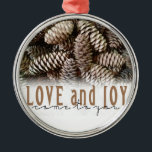 Rustic Holiday Love and Joy Pine Cone Metal Ornament<br><div class="desc">Festive,  rustic pine cones accentuate this classic,  elegant design wishing holiday Love and Joy.</div>