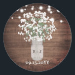 Rustic Monogram Mason Jar Vase Lights Wedding Classic Round Sticker<br><div class="desc">This design features dainty watercolor baby's breath flowers in a monogrammed mason jar vase on a rustic wood background with string lights. Click the customize button for more flexibility in modifying the text or moving the graphics! Variations of this design as well as coordinating products are available in our shop,...</div>