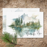 Rustic Mountain Lake Scene Watercolor Wedding Thank You Card<br><div class="desc">Escape to a serene mountain retreat with your wedding thank you card. This exquisite design showcases a breathtaking watercolor painting of a majestic mountain, its slopes draped in lush pine trees, mirroring their beauty in the crystal-clear waters below. The muted natural tones of tan, greens, teal blues, and greys create...</div>