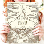 Rustic Mountain Landscape Custom Name Planner<br><div class="desc">This charming design features a hand-drawn mountain landscape with intricate details of ferns, mushrooms, and a winding river, all in earthy brown tones. The personalized name and year add a thoughtful touch, making it perfect for nature lovers and adventurers. Ideal for journalling, goal-setting, or daily planning with an inspiring and...</div>