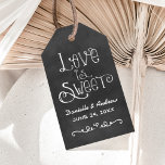Rustic Script Chalkboard Wedding Love is Sweet Gift Tags<br><div class="desc">Charming chalkboard cardstock favour tags feature "Love is Sweet" with a custom wedding monogram in handwritten style fonts with a heart and scroll design accent that have a white chalk appearance. Background has a rustic black board textured appearance.</div>