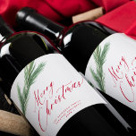 Rustic watercolor pine bough Christmas red white Wine Label<br><div class="desc">Elegant red script Merry Christmas holiday wine label featuring green pine needles bough over a clean white background.              Easy to personalize with your name,  text,  and year.</div>
