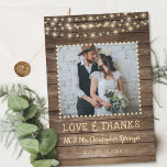 Rustic Wood and String Lights Wedding Thank You<br><div class="desc">Your wedding photo is accented with a rustic, country, brown weathered wood plank background and soft yellow glow string lights along with the title of LOVE & THANKS and your wedding date in a country western hand-printed font and your name in a rough brush script font. The back of the...</div>
