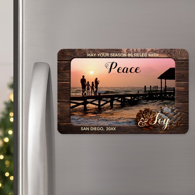 Rustic Wood Personalized Holiday Photo Magnet (A Christmas magnet featuring your custom photo framed by rustic dark wood and festive pine cone)