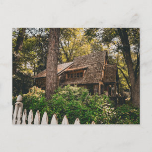 Rustic Wooden Cabin in Forest with Picket Fence Postcard