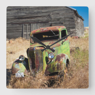 Rusting car in front of abandoned farm square wall clock