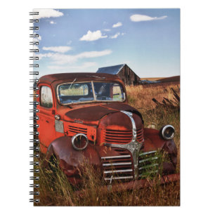 Rusting orange Dodge truck with abandoned farm Notebook