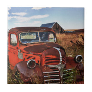 Rusting orange Dodge truck with abandoned farm Tile