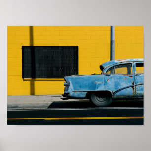 Rusty Blue Car and Yellow Wall Poster