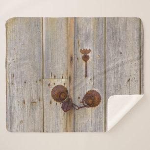 Rusty vintage old iron padlock on a wooden door .. sherpa blanket