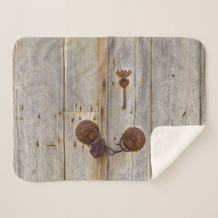 Rusty vintage old iron padlock on a wooden door sherpa blanket