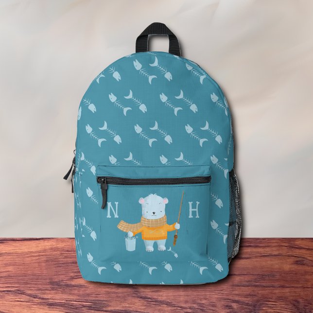 Sac à dos bleu pour l'ours polaire de pêche (Adorable kid blue backpack with a polar back holding a fishing rod .
)