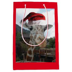 Sac Cadeau Moyen Une girafe portant un Casquette du Père Noël pou