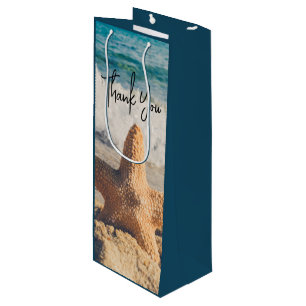 Sac Cadeau Pour Bouteille Starfish sur une plage de sable Photo