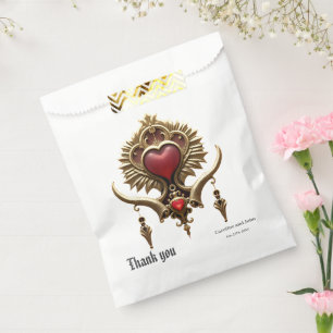 Sachets En Papier Élégance en lustre rouge avec un coeur orné.