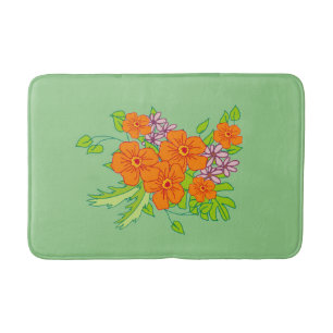 Sage green bath mat with orange flower,