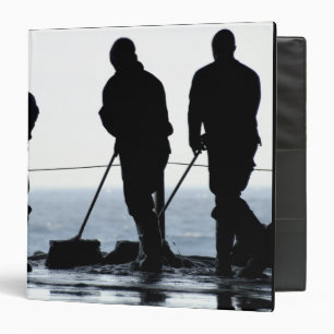 Sailors sweep out the hangar bay binder