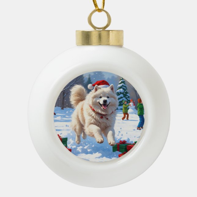 Samoyed Running in Snow with Christmas Hat Ceramic Ball Christmas Ornament (Front)