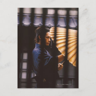 Samurai warrior keeping an umbrella postcard