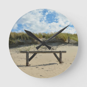 Sand dunes with wooden fence round clock
