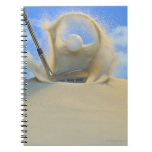 sand wedge hitting a golf ball out of a sand 2 notebook