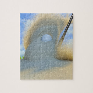 sand wedge hitting a golf ball out of a sand jigsaw puzzle