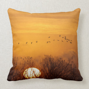 Sandhill cranes silhouetted aginst rising sun throw pillow