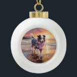 Sandy Australian Shepherd Dog on Beach Sunset  Ceramic Ball Christmas Ornament<br><div class="desc">Immerse yourself in the tranquil beauty of our "Sandy Paws and Sunset Hues" dog on beach sunset design. This captivating scene captures the essence of a perfect evening at the shore, with a loyal canine companion enjoying the golden sands and the breathtaking hues of the setting sun. Whether you're a...</div>