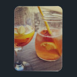 Sangria and Sunshine Magnet<br><div class="desc">This image shows a refreshing glass and pitcher of citrus sangria, perfect for a warm day. The fresh slices of lemon and orange add bright colour and hint of natural sweetness. One glass sits ready to enjoy while sangria is being poured from a small glass pitcher beside it, perfect for...</div>