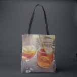 Sangria and Sunshine Tote Bag<br><div class="desc">This image shows a refreshing glass and pitcher of citrus sangria, perfect for a warm day. The fresh slices of lemon and orange add bright colour and hint of natural sweetness. One glass sits ready to enjoy while sangria is being poured from a small glass pitcher beside it, perfect for...</div>