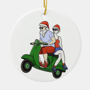 Santa and Mrs. Claus riding a scooter Ceramic Ornament