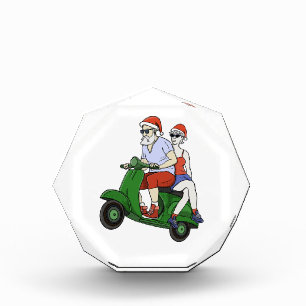 Santa and Mrs. Claus riding a scooter Photo Block