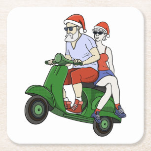 Santa and Mrs. Claus riding a scooter Square Paper Coaster