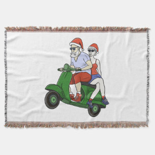 Santa and Mrs. Claus riding a scooter Throw Blanket