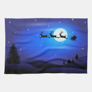 Santa and Reindeer Flying Across Blue Night Sky Kitchen Towel