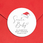 Santa Baby Christmas Baby Shower Classic Round Sticker<br><div class="desc">Cute stickers for your Christmas holiday season baby shower correspondence and party favours with "Santa Baby" in an elegant script with a heart swash and a watercolor illustration of a red Santa Claus hat. Personalize with the mother's name and shower date in simple modern typography.</div>