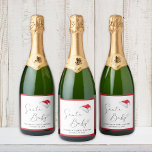 Santa Baby Christmas Baby Shower Sparkling Wine Label<br><div class="desc">Cute sparkling wine labels for your Christmas baby shower featuring "Santa Baby" in a chic script with a heart swash,  a watercolor of Santa's red hat,  and the name of the mommy-to-be and the shower date in simple topography.</div>
