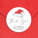 Santa Baby Christmas Baby Shower Thank You Classic Round Sticker<br><div class="desc">Cute stickers for your Christmas holiday season baby shower correspondence and party favours with "Thank You" in an elegant script with a heart swash and a watercolor illustration of a red Santa Claus hat. Personalize with the mother's name and shower date in simple modern typography.</div>
